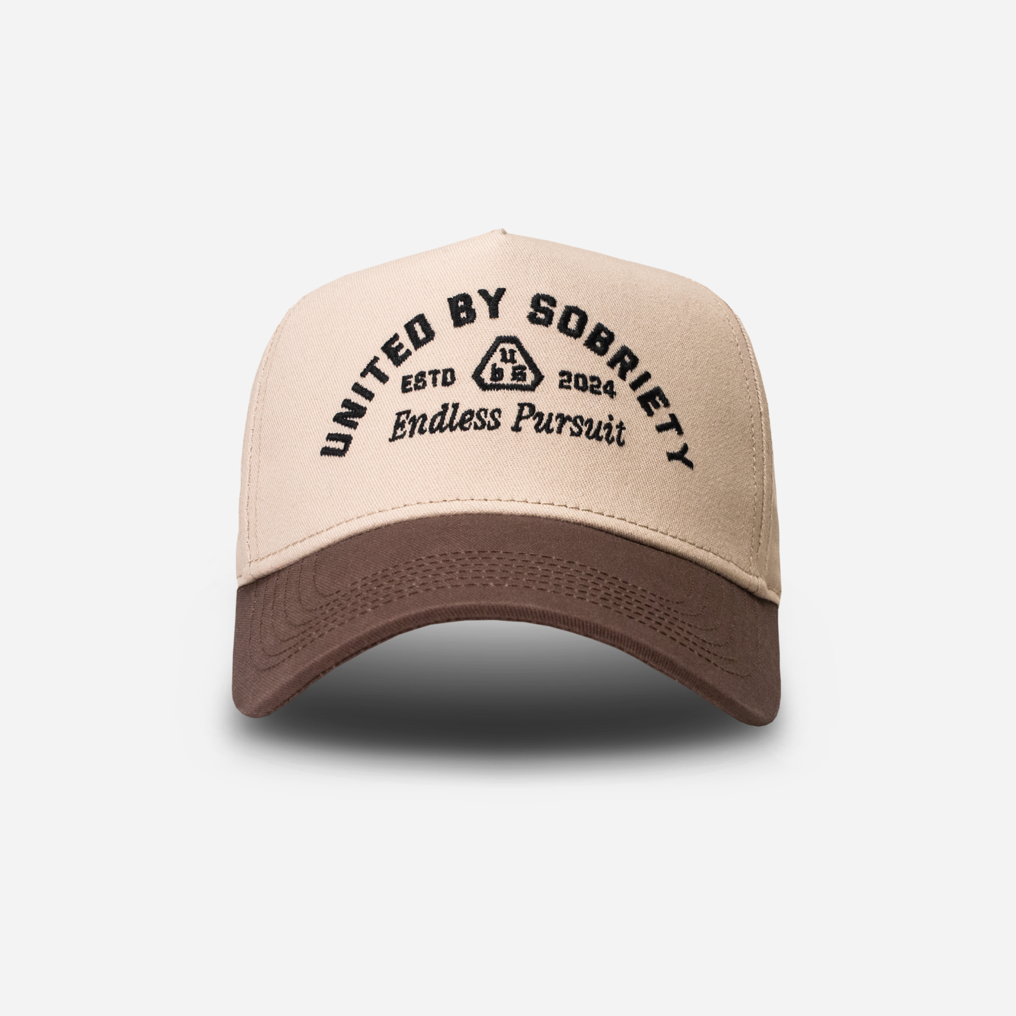 Beige A-Frame cap with brown brim featuring text-United HeadWear